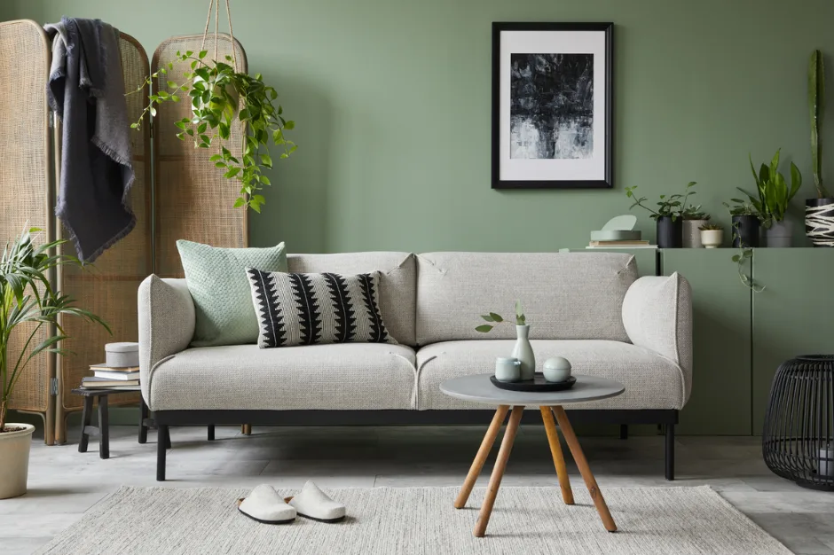 A cozy linen couch is staged in a serene, inviting living room