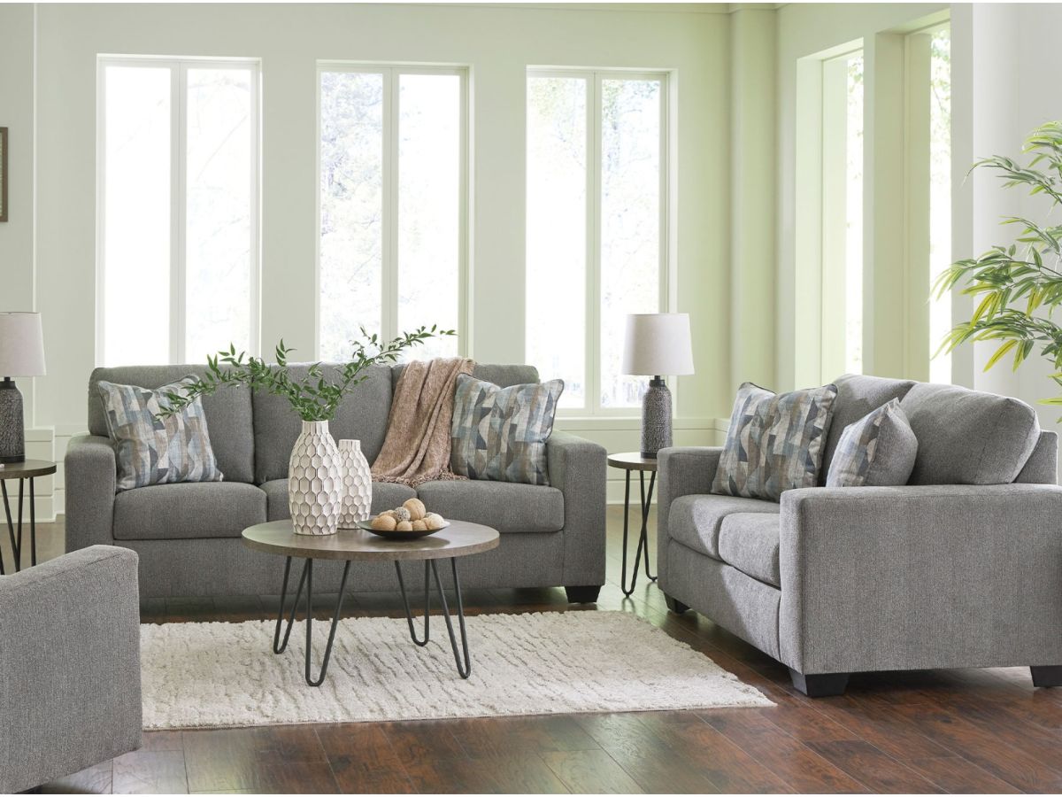 A living room with a matching sofa and loveseat