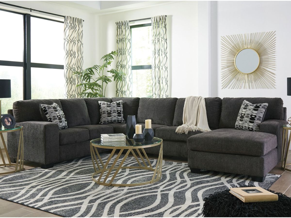 A living room with a dark grey sectional