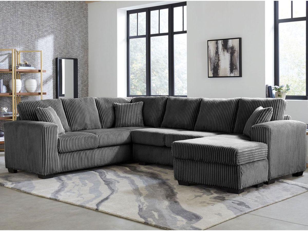 A dark grey sectional in a modern living room