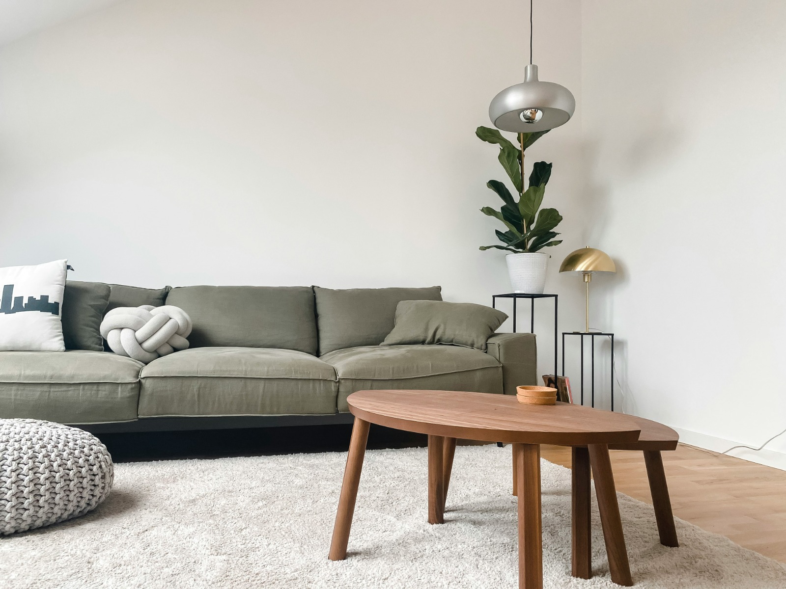 A green sofa in a light living room