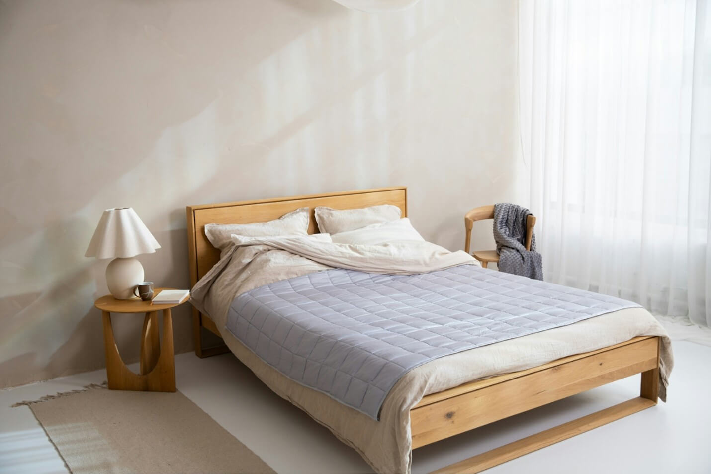 A bed in a simple, well-lit bedroom