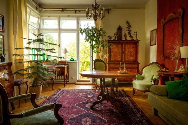 A living room with antique furniture and dark, rich colours