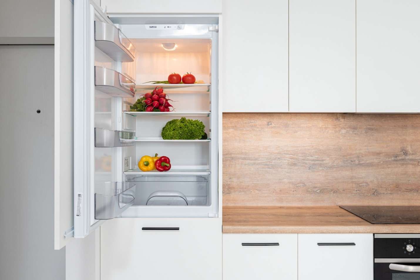 Person cleaning fridge shelves