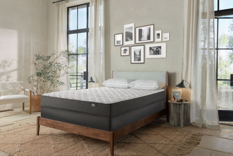Grey mattress on a brown bed frame