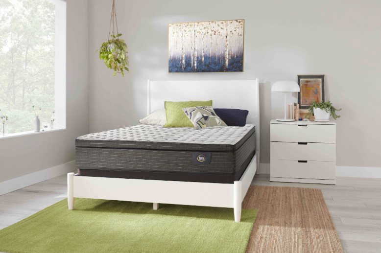 White and grey mattress on a white bed frame
