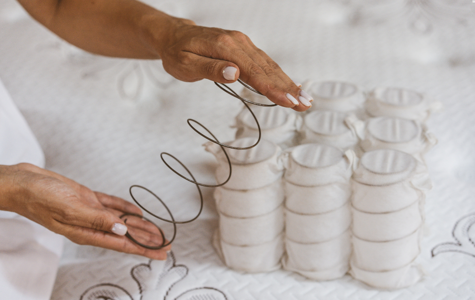 Production workers assembling a pocket coil mattress