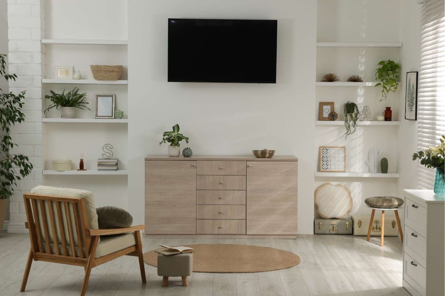 Wall-mounted TV in a living room with white walls