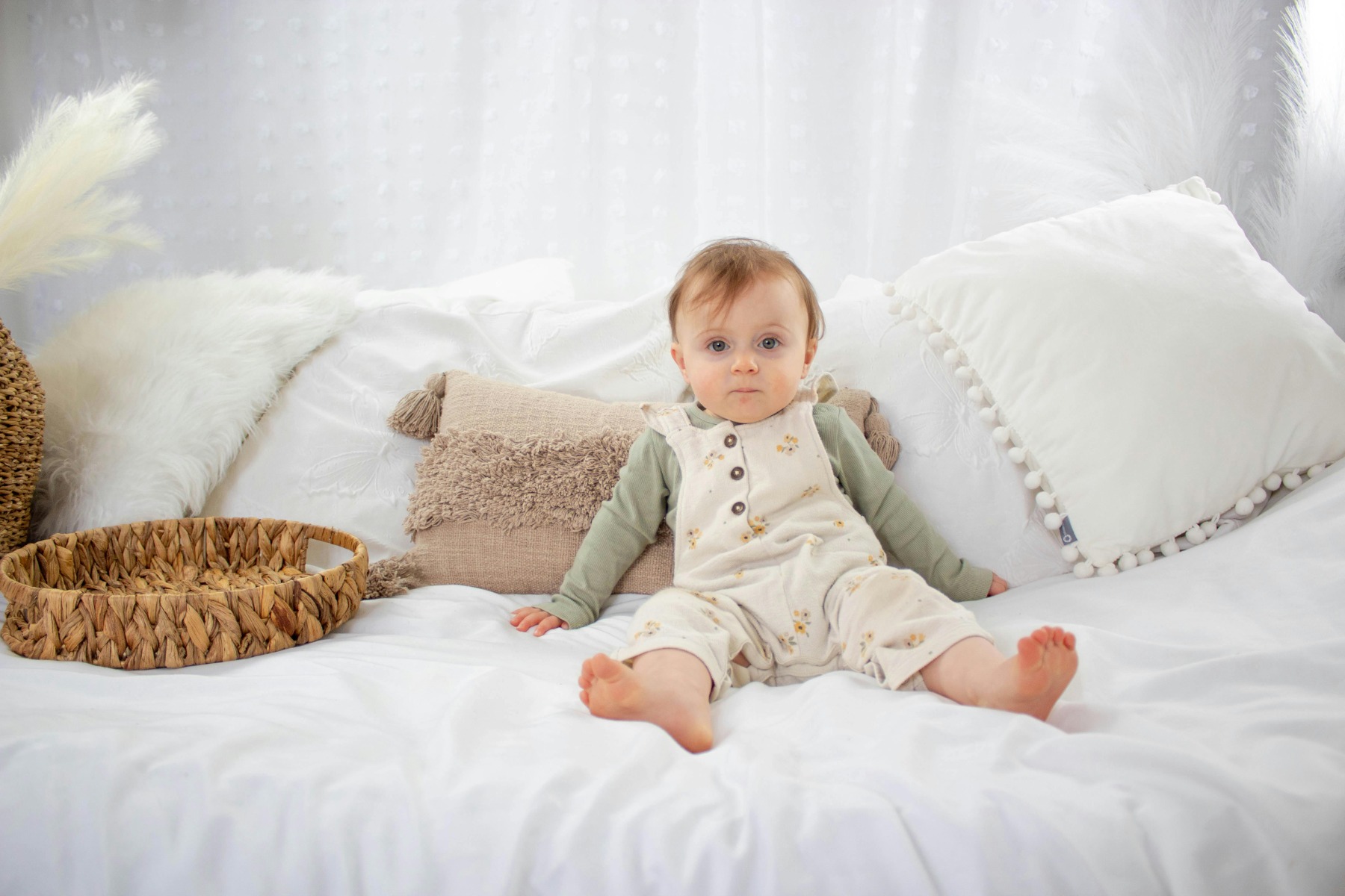 A small baby in a big bed alone