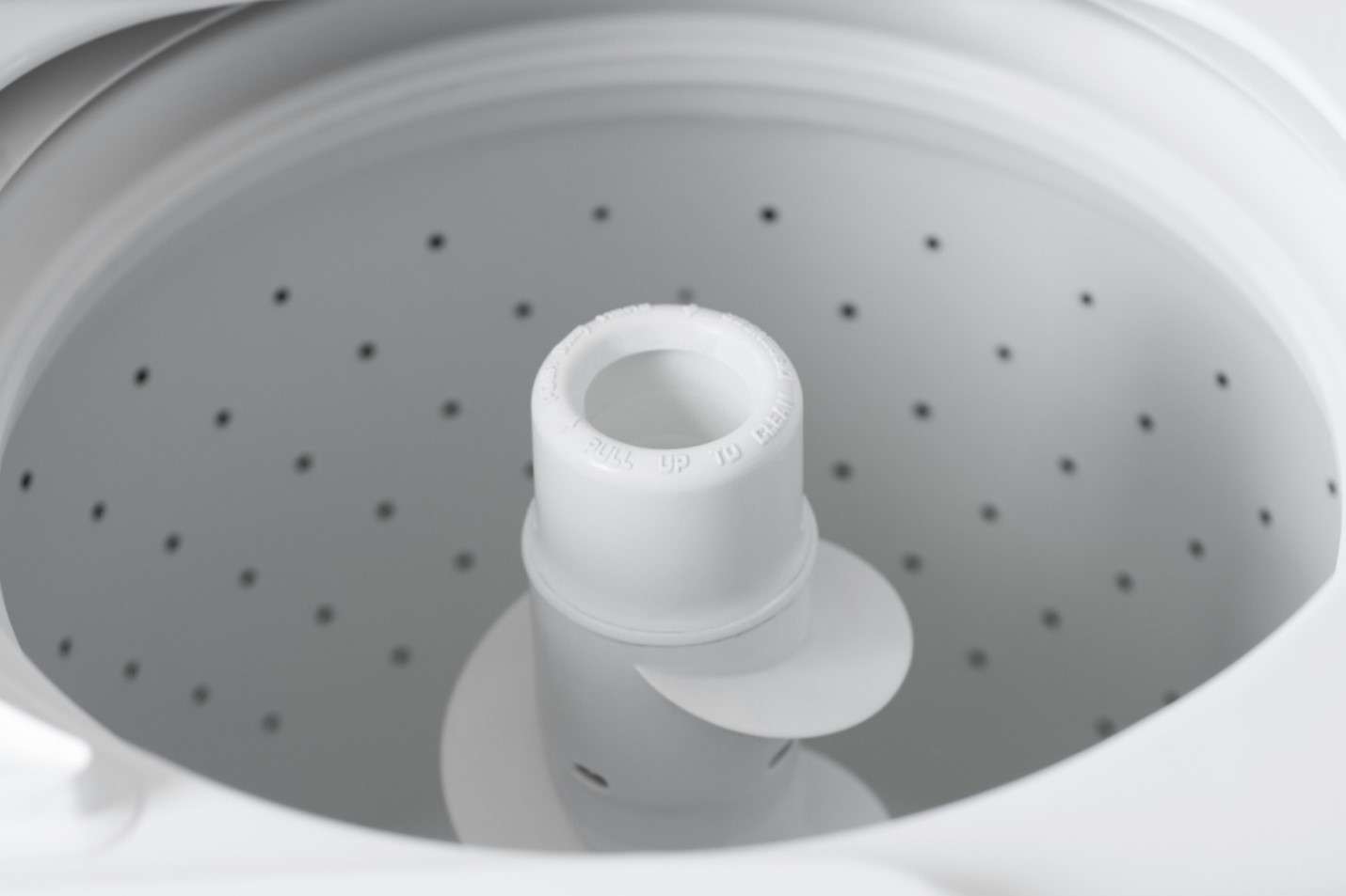 Inside a top-load washing machine with the agitator in the middle
