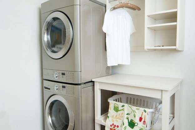 A washer and dryer stacked on top of each other in a laundry room