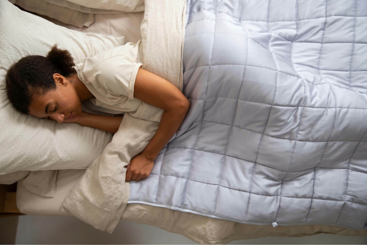 A woman asleep in her comfortable bed