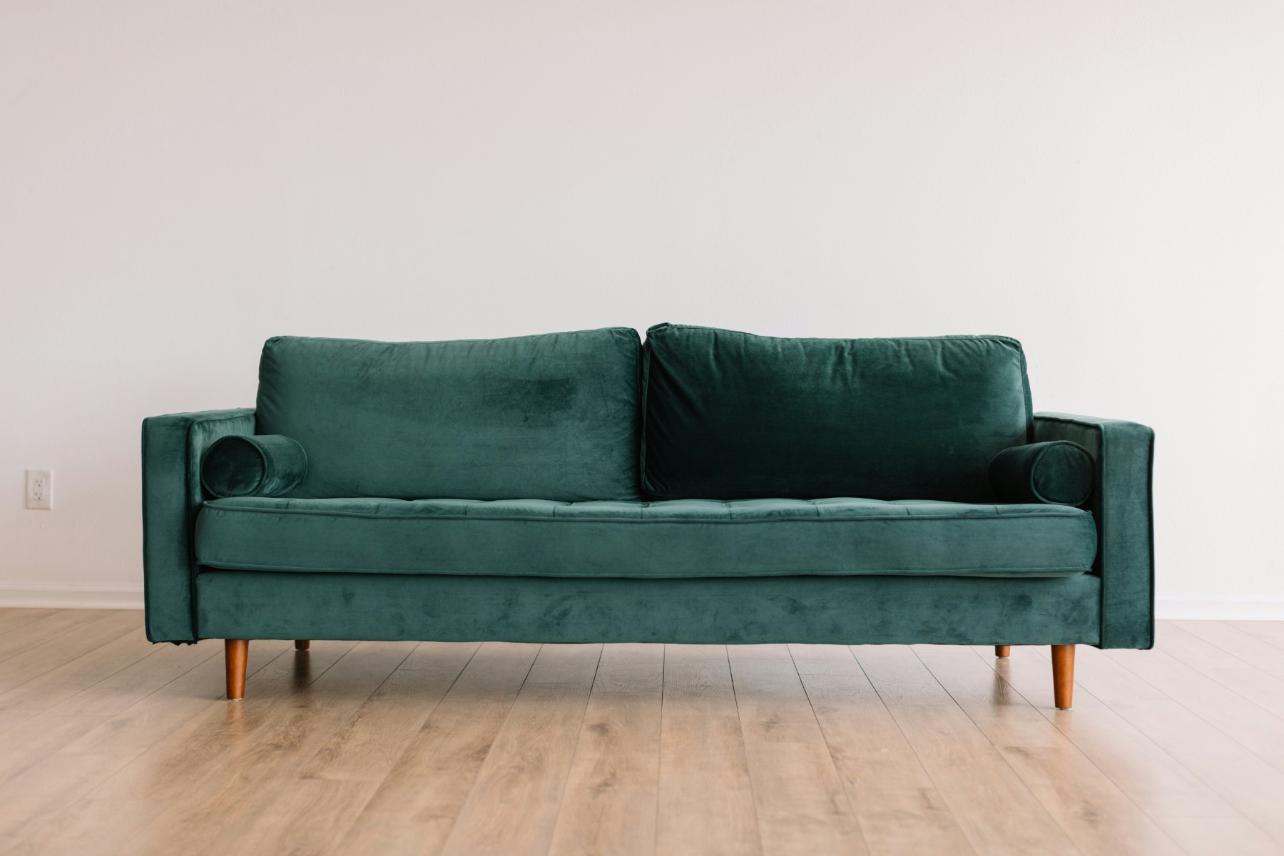 A velvet sofa adding luxury to a living-room corner